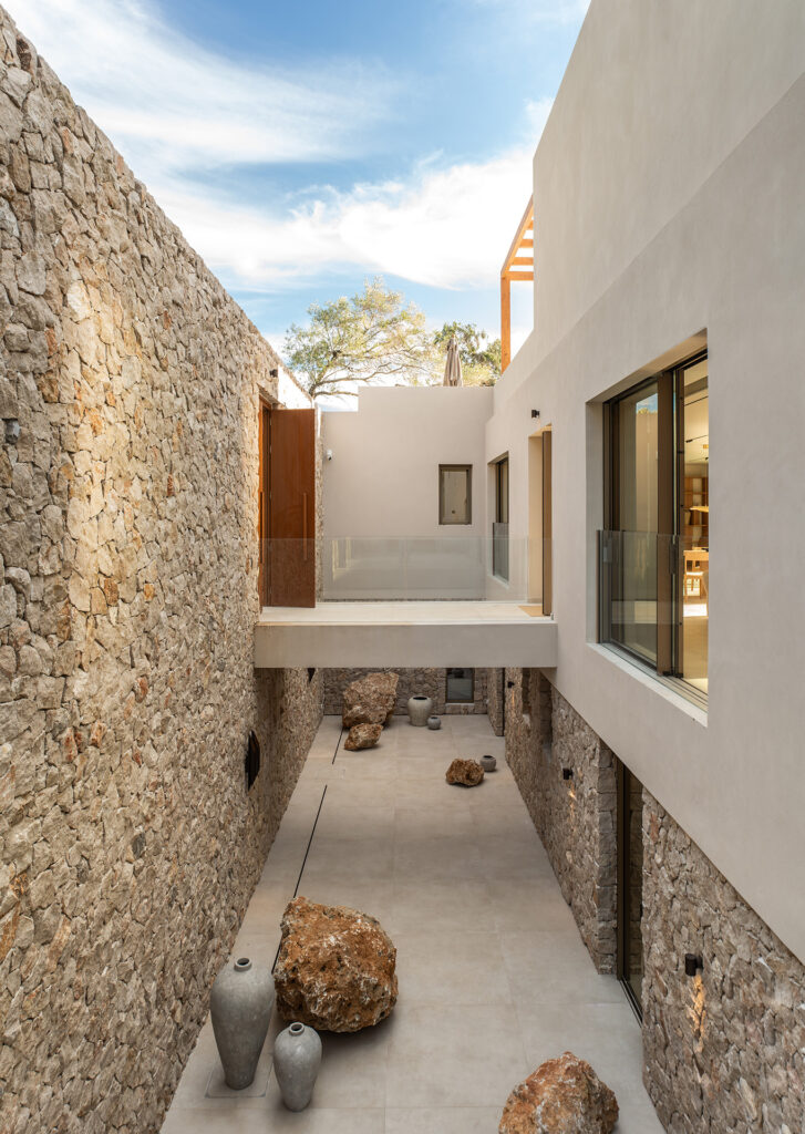 thetacon prasoudi cliff house medditerrenean residential architecture modern stone vila outside atrium entrance